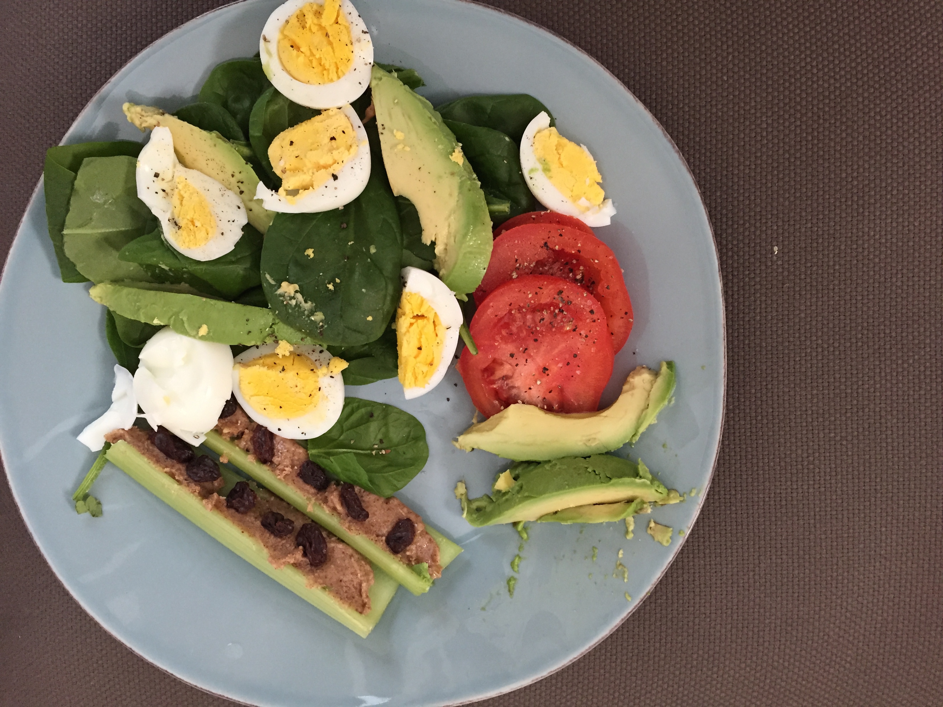 spinach, egg, tomato, avocado, celery with homemade almond butter and unsweetened raisons